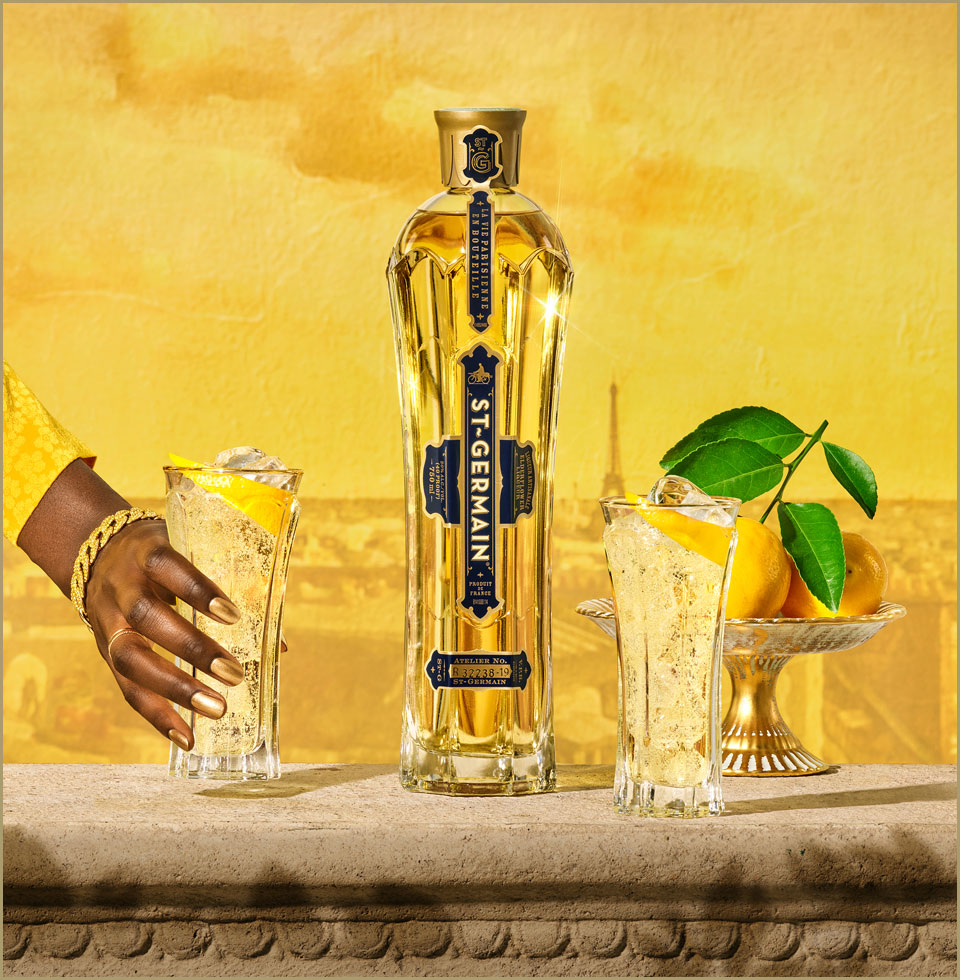 girl holding glass with ST~GERMAIN bottle